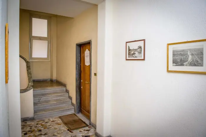 L'ingresso della casa sul pianerottolo, con la scala del palazzo
